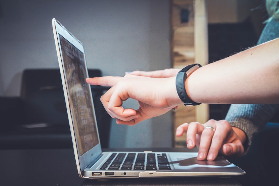 Person pointing at a computer screen