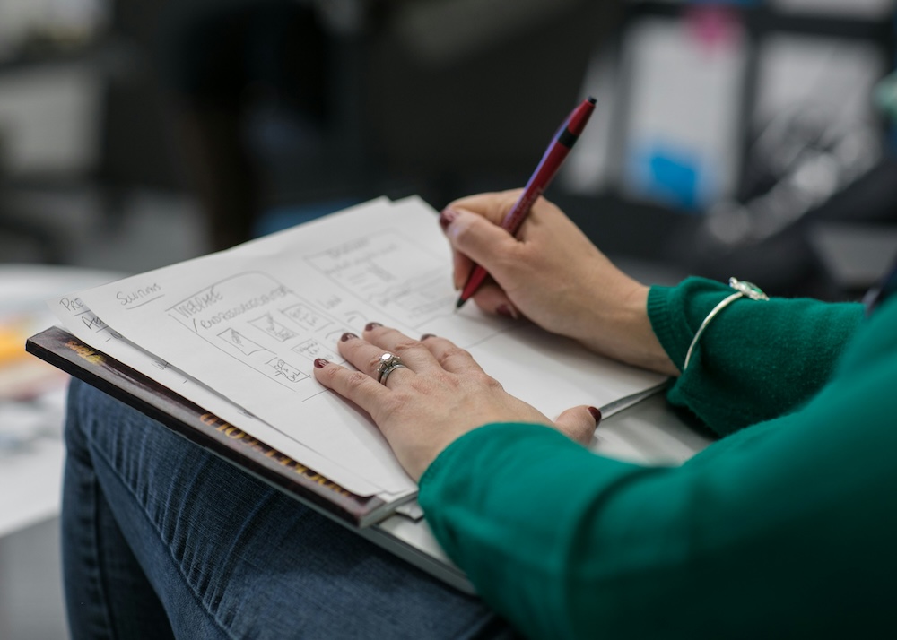 Person sketching wireframes on a tablet